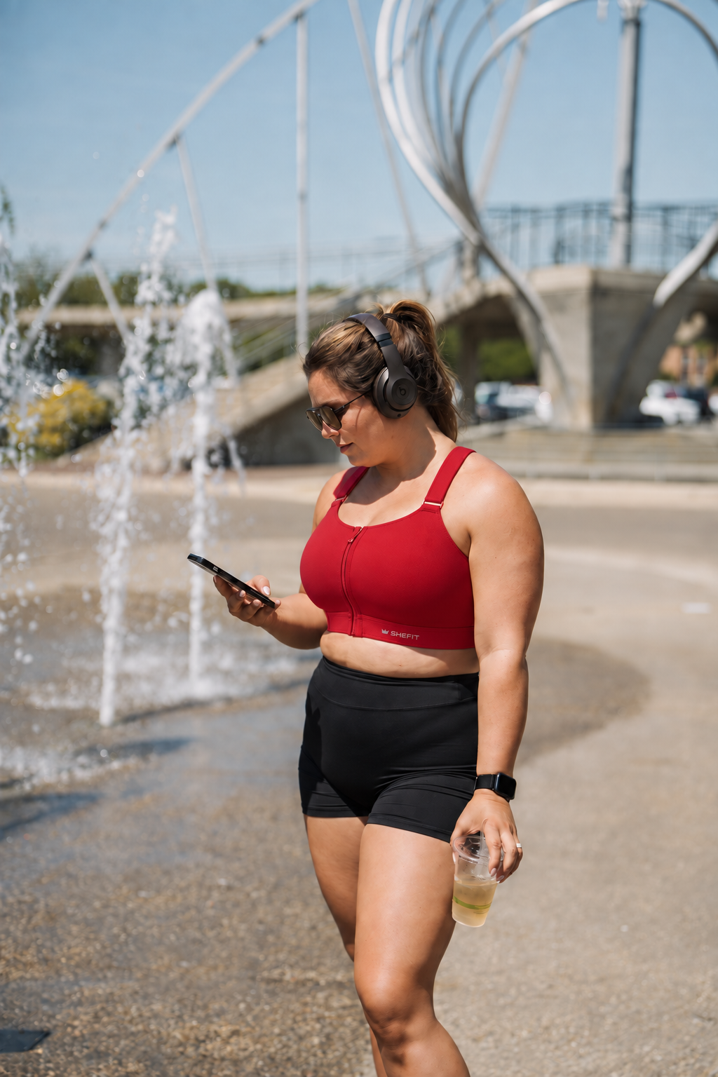 Emerge Sports Bra in Scarlet Heat; original headphones and phone fountain photograph